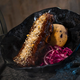 The Smoked Kaadu Ribs, found at Docking Bay 7 Food and Cargo features smoked country sticky pork ribs with blueberry corn muffin and cabbage slaw.